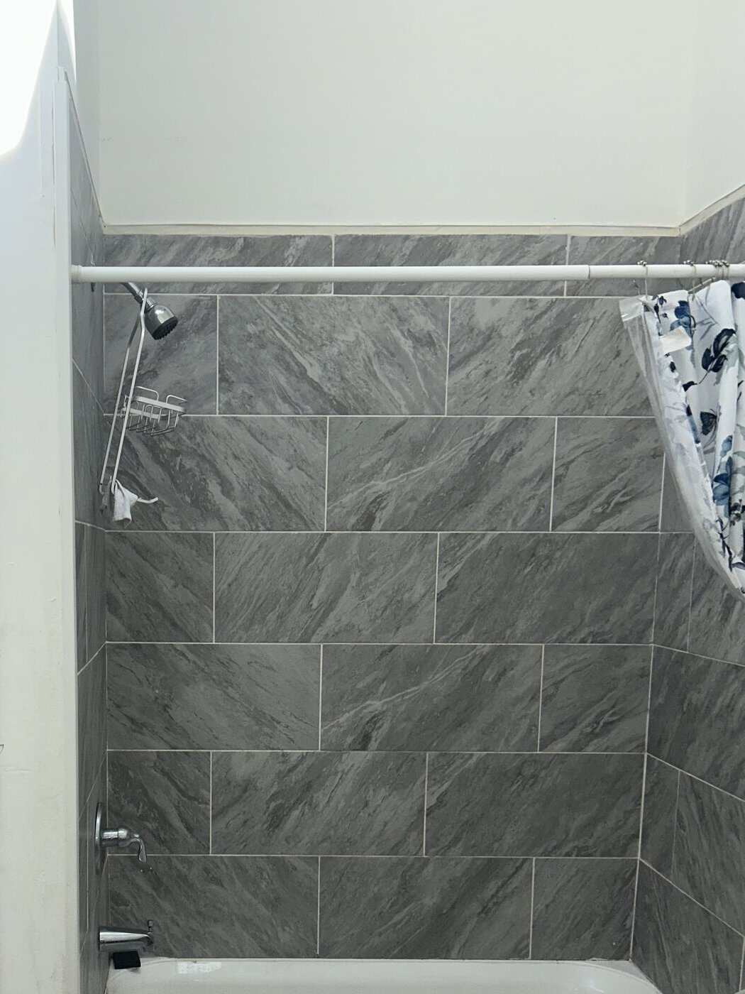 Newly installed bathtub and tile surround in a multi-unit residential bathroom in Cresskill, NJ